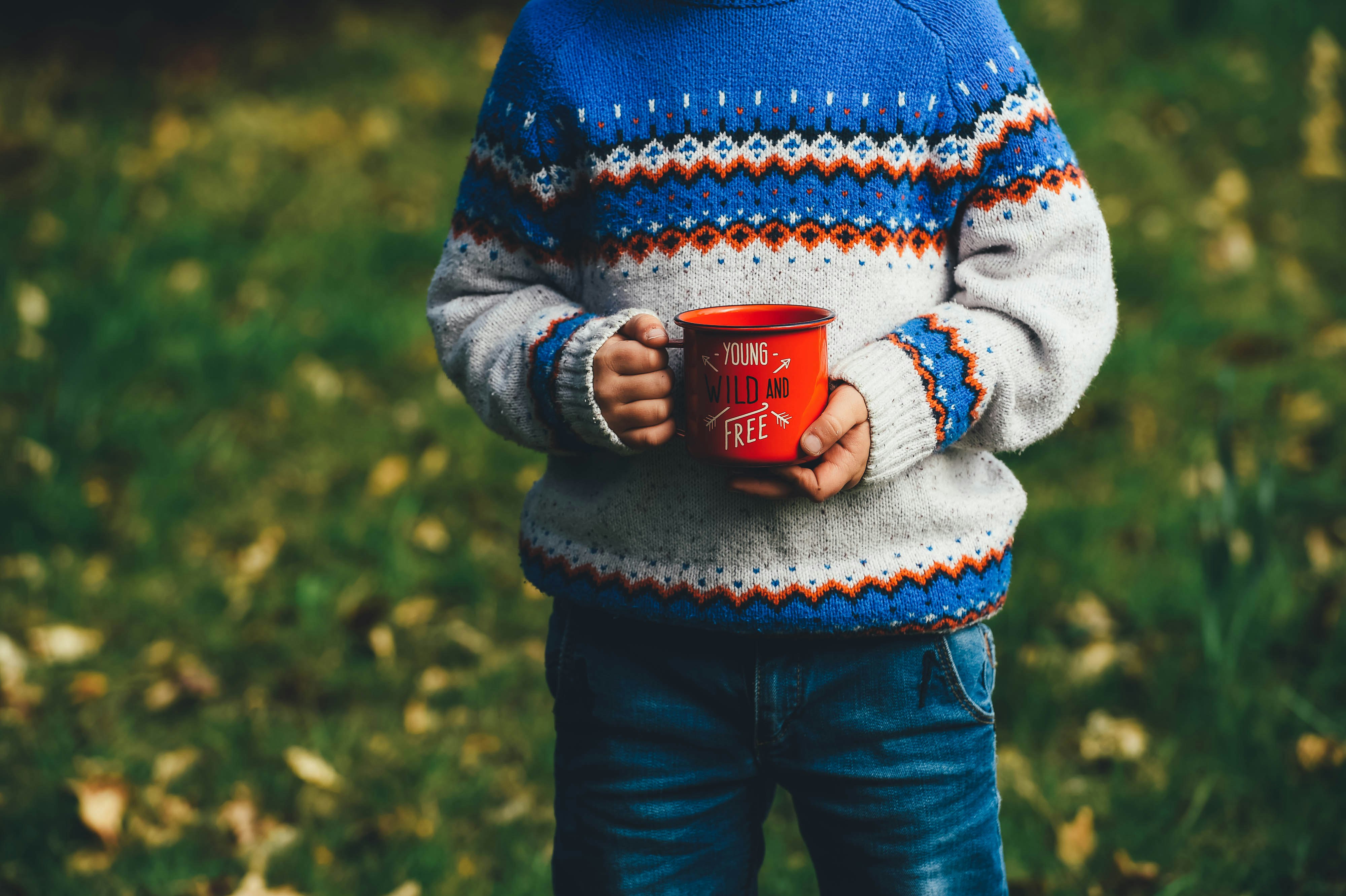 person holding ceramic mug